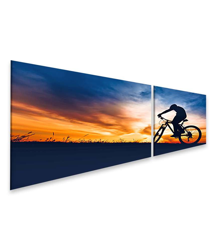 Islandburner Bild auf Leinwand Silhouette eines Sportlers auf Mountainbike beim Sonnenuntergang auf einem Hügel